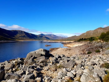 Scenic view of lake against blue sky