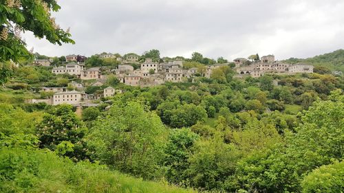 Panoramic view of trees and buildings against sky
