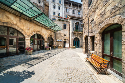 Footpath amidst buildings in city