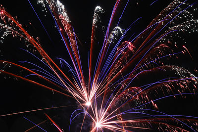 Low angle view of firework display at night