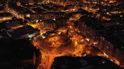 High angle view of illuminated street amidst buildings in city