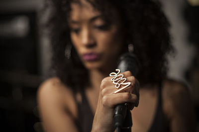 Close-up of woman singing on microphone