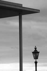 Low angle view of street light against cloudy sky