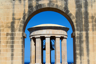 Low angle view of historical building against clear blue sky