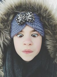 Close-up of girl making a face in warm clothes