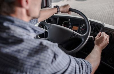 Rear view of man driving truck