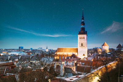 Buildings in city against sky at night