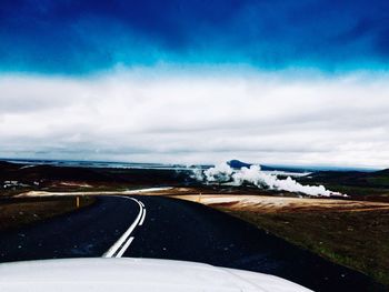 Road by landscape against sky