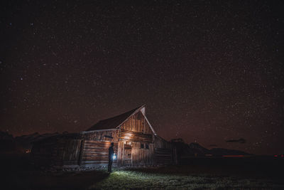 Low angle view of illuminated buildings against sky at night