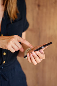 Midsection of woman using mobile phone