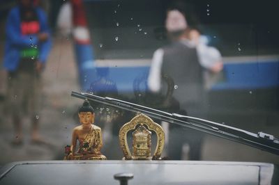 Close-up of metallic buddha in vehicle