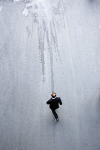 High angle view of man walking on road