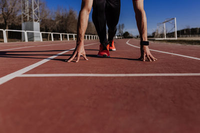 Low section of person running on sidewalk