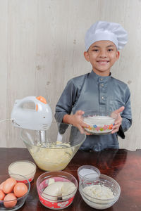 Portrait of boy preparing food in bowl