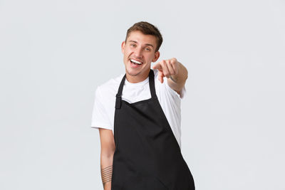 Portrait of a smiling young man against white background