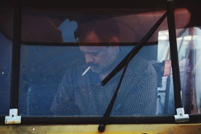 Man seen through window