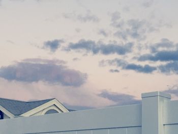 Low angle view of house roof against sky