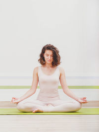 Young woman meditating in yoga studio