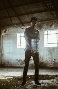 Full length of man standing in abandoned building