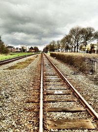 Railroad track against cloudy sky