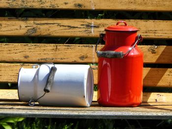 Milk cans on bench