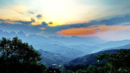 Scenic view of mountains against sky at sunset