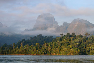 Scenic view of lake and mountains against sky