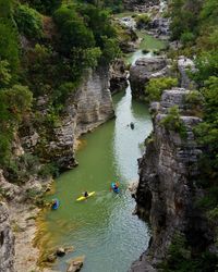 High angle view of people kayaking in sea