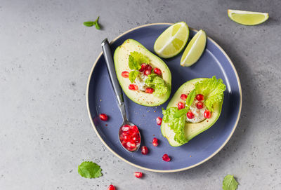 Avocado with pomegranate seeds, ricotta, lettuce and mint.