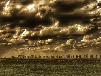 Scenic view of agricultural field against storm clouds