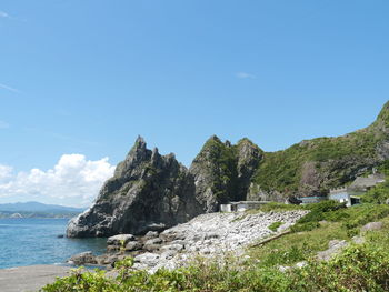 Scenic view of sea and mountains against sky
