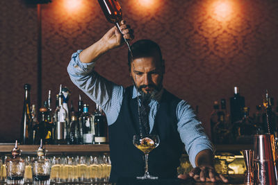 Bartender preparing cocktail in bar