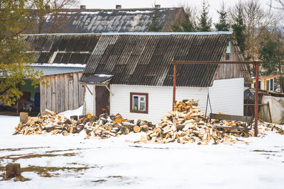 Tree and house on field during winter