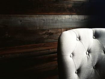 Close-up of man sitting on sofa