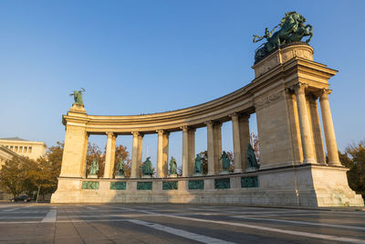 Low angle view of statue against blue sky