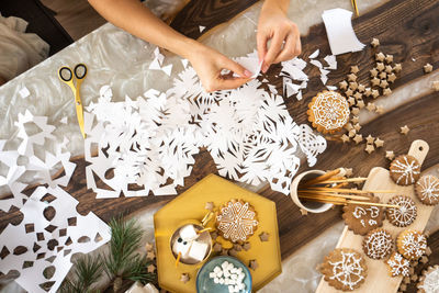 High angle view of woman hands on table