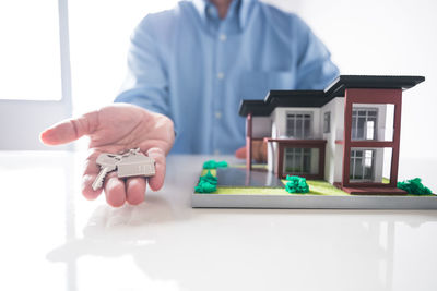 Close-up of man holding camera on table