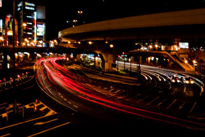 Light trails on road in city at night