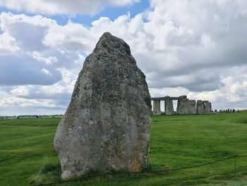 Built structure on field against cloudy sky