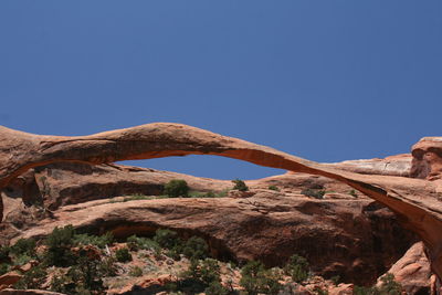 Low angle view of natural arch against clear sky at arches national park