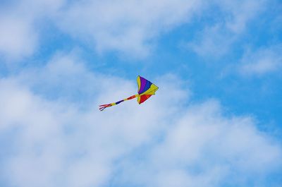 Low angle view of kite flying against sky