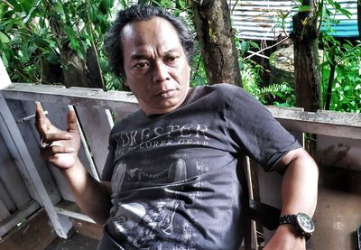 Portrait of young man sitting outdoors