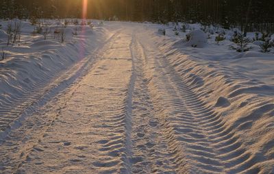 Tire tracks on snow covered field