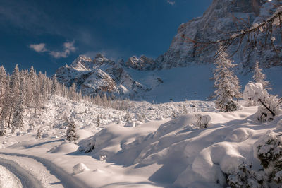 Scenic view of snow covered mountains against sky