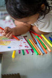 Cute girl drawing on paper