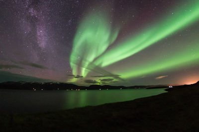 Aurora polaris over lake at night