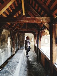 Full length of woman standing in building