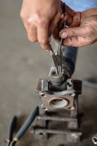 Cropped image of man repairing machine part