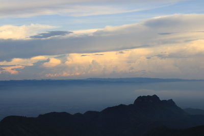 Scenic view of silhouette mountain against dramatic sky