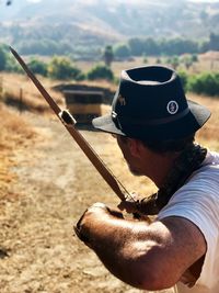 Man holding hat on field